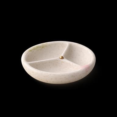 A ceramic divided dish — money set aside in its own place